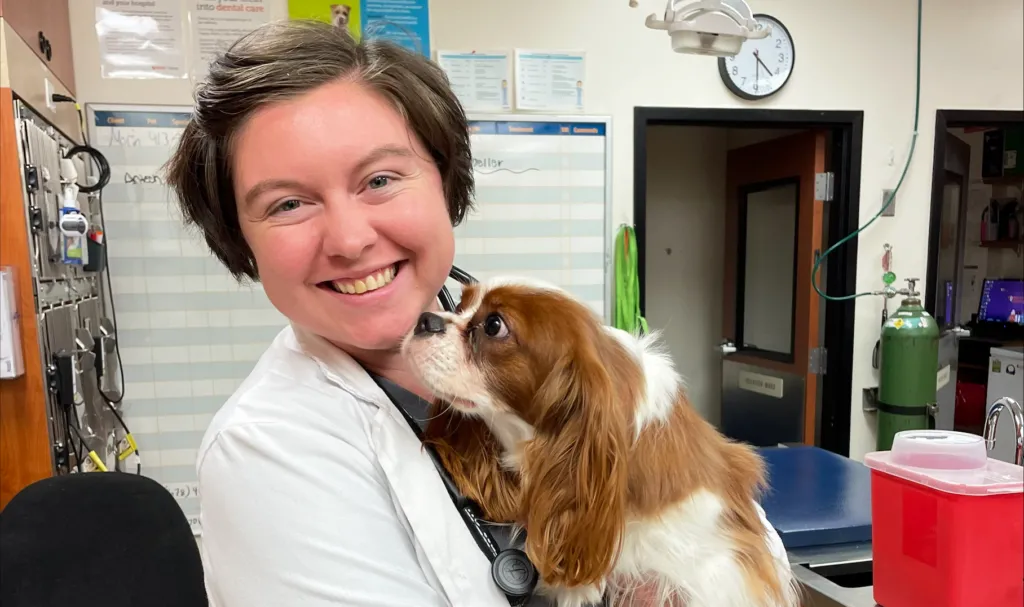 Photo of associate IndeVet holding a dog in the exam room