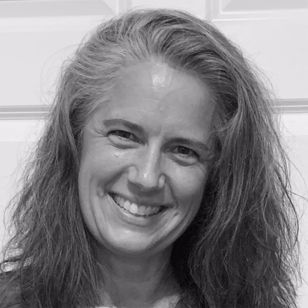 Black-and-white headshot of Dr. Melissa Mroziak, who has wavy long hair and is smiling.
