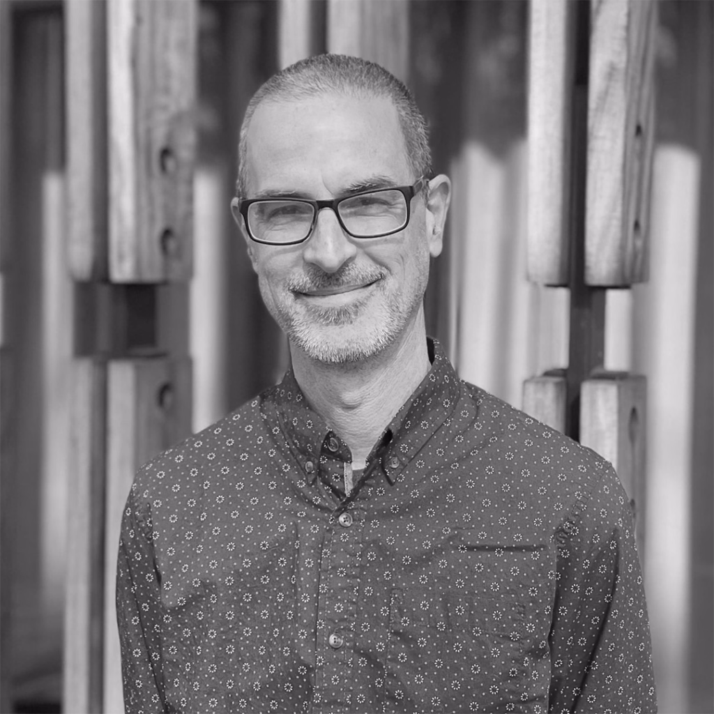 Black and white headshot of Dave Shuey