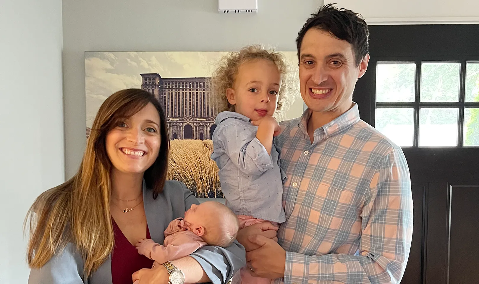 Photograph of two parents, each holding a child.