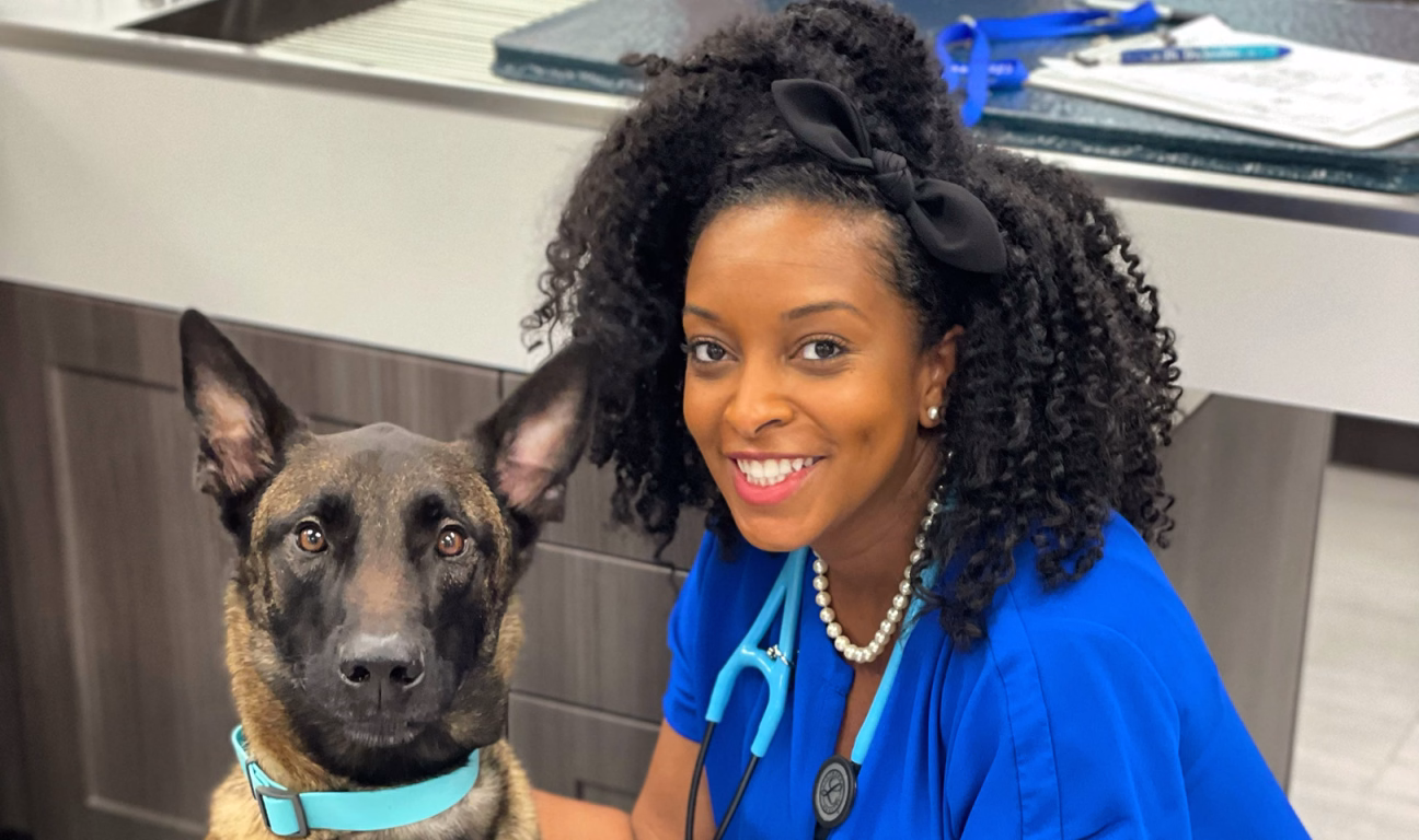 Photo of Dr. Auvian beside a dog