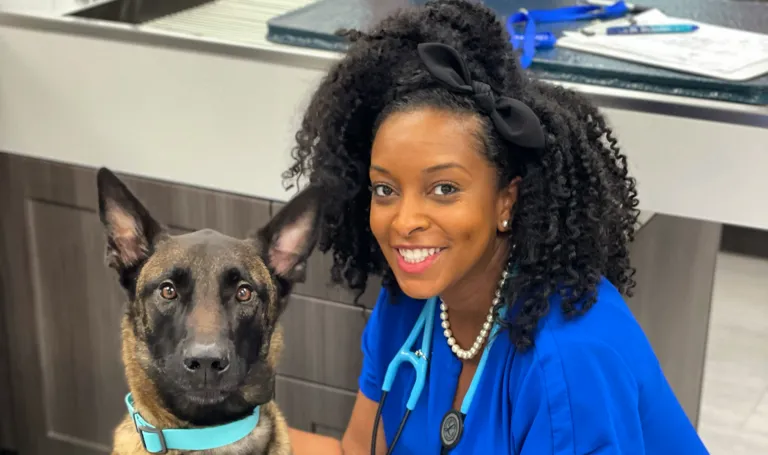 Photo of Dr. Auvian beside a dog