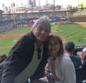 photo of Dr. Natalie Paul and her husband at a Mariner's game