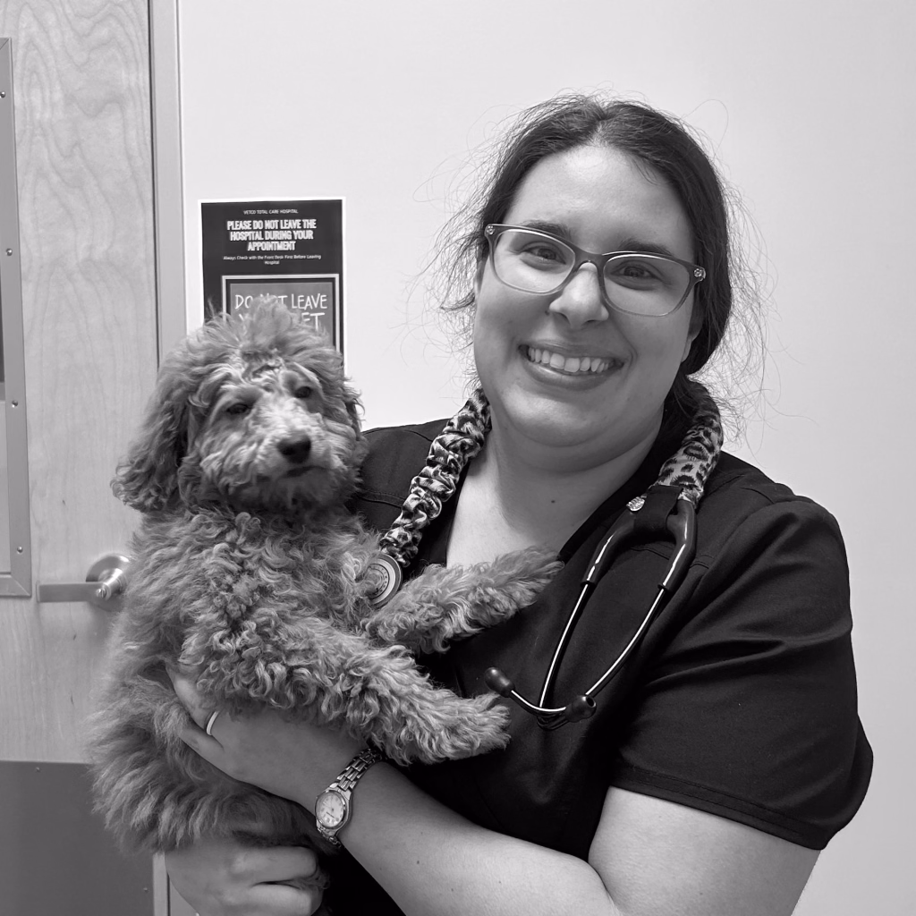 Black-and-white photo of Dr. Gianna Marco holding a small dog