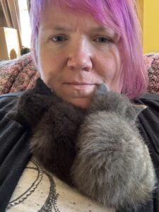 Dr. Kantola with two kittens sleeping on her chest