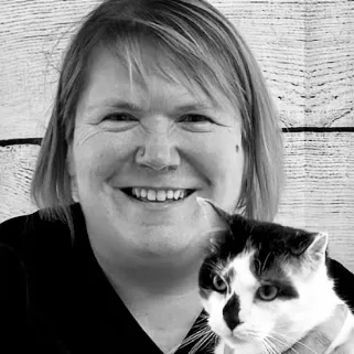 Headshot of Dr. Kantola holding a black-and-white cat